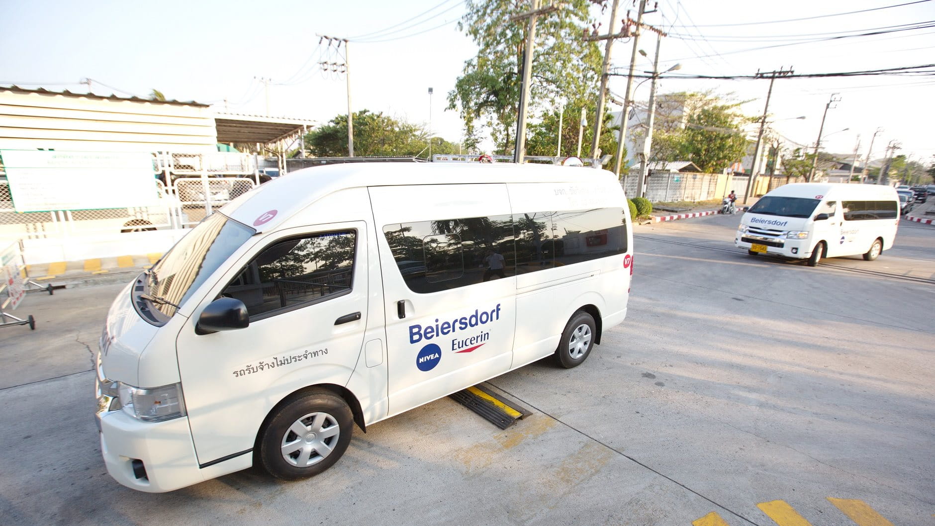 Rewards & Benefits Career - white Beiersdorf van for employees driving down a street